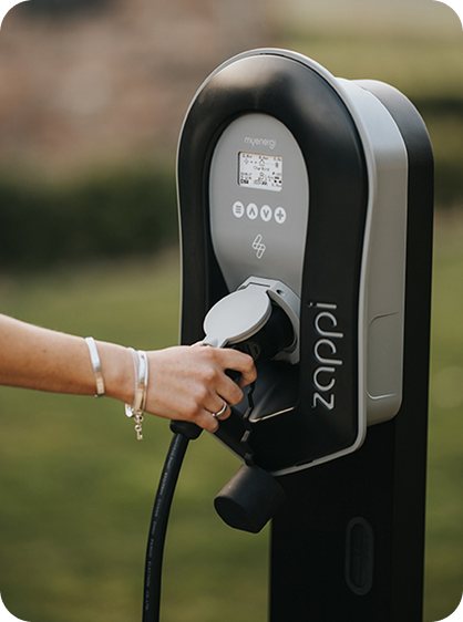 Plugging a myenergi Zappi EV charger into a car on the driveway